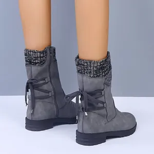 Detailed back view of grey mid-calf boots with knit cuff and lace-up design.