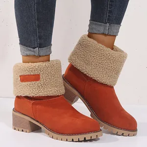 Detail view of orange suede winter boots with plush fleece cuffs and block heels.