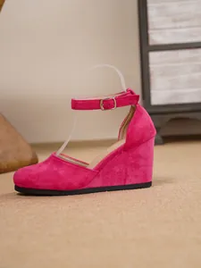 Seitenansicht von rosa Wildleder-Keilsandalen mit geschlossener Spitze und Knöchelriemen