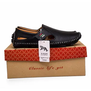 Classic black leather loafers with white stitching detail and original shoebox packaging
