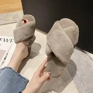Close-up of cross-strap fuzzy slippers with soft plush texture for indoor comfort
