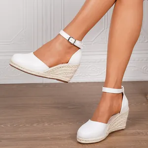 Elegant women's white wedge espadrille sandals featuring ankle strap and round toe
