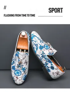 Detailed macro view of stylish men's floral loafers featuring decorative metallic tassels