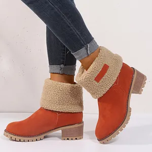 Orange suede-like winter snow boots with warm beige shearling cuff and chunky lug sole