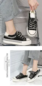Macro view of black platform canvas sneakers with unique white braided design