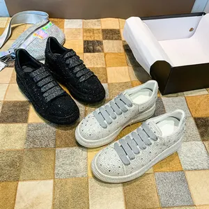 Close-up detail of luxurious black and white rhinestone platform sneakers for women