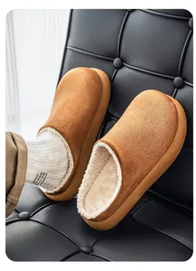 Close-up of warm brown suede clogs with soft white fleece lining and thick sole.
