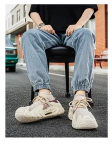 Beige Flyknit sneakers with chunky textured soles and colorful accents for urban streetwear.