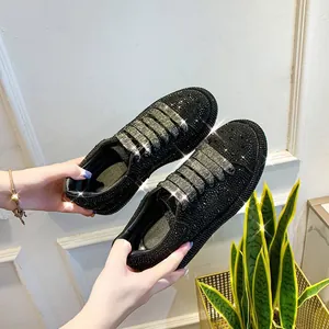 Detailed close-up of shiny black rhinestone platform sneakers for women with elastic straps