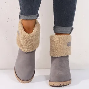Detailed view of women's grey winter snow boots with beige fleece lining and lug sole