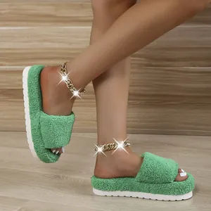 Detail view of green fuzzy towel material slides with thick white platform sole