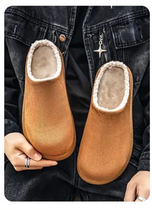 Detailed macro view of men's camel suede clogs featuring warm white fleece lining