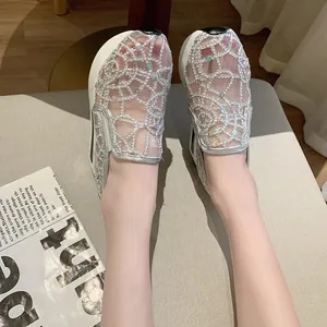 Detailed view of elegant lace mesh platform shoes featuring sparkly sequin detailing