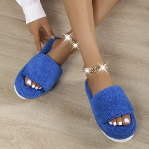 Close-up detail of stylish blue fuzzy slides with thick soles worn with gold anklets