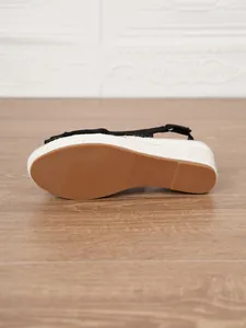 Durable rubber outsole of women's espadrille wedge sandals showing anti-slip texture