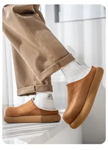 Detailed side view of brown suede platform clogs featuring warm white fleece lining and khaki pants.