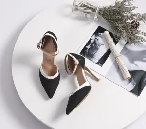 Elegant pointed-toe stiletto heels featuring navy denim texture and white trim accents