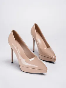 Elegant nude patent leather pointed toe pumps with ultra-high stiletto heels and platforms.