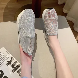 Detail view of stylish silver lace mesh platform loafers featuring sparkly sequin accents