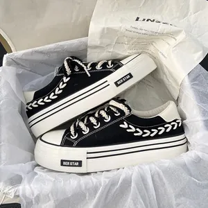 Women's black canvas platform sneakers with braided rope details and thick white soles