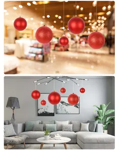 Red festive decorative balls in matte and shiny finishes hanging in modern living room