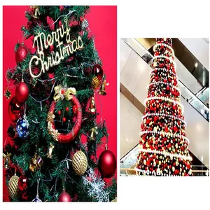 Macro view of red and gold glitter Christmas ornaments on a festive tree and mall display.