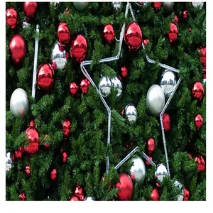 Detailed close-up of red and silver glossy Christmas baubles on green pine branches