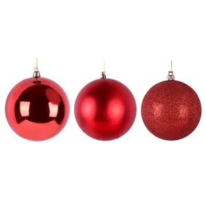 Set of three red Christmas ball ornaments featuring shiny matte and glitter finishes on white background