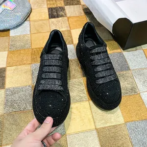 Macro detail of luxury black rhinestone sneakers for women featuring platform soles
