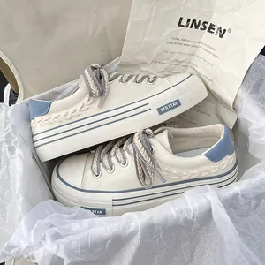 Stylish women's platform white canvas shoes with blue accents and thick woven laces