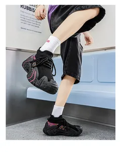 Modern black knit sneakers with colorful details shown in a trendy subway lifestyle setting