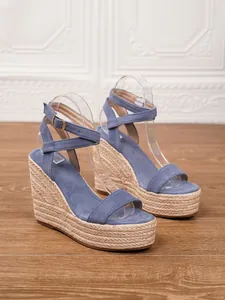Vista detallada de sandalias con cuña de ante azul y plataforma de cáñamo trenzado