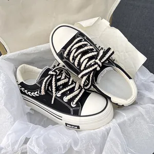 Stylish black and white chunky platform canvas sneakers with unique braided laces detail