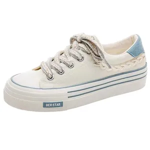 Women's white platform canvas sneakers with braided laces and casual breathable design