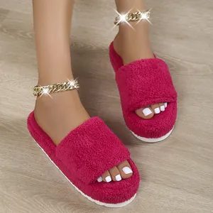 Detailed view of magenta furry platform slides with white soles on wooden floor