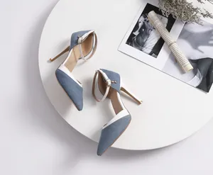 Detailed view of elegant blue denim slingback stiletto heels with pointed toe design.
