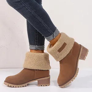 Detail view of brown suede winter boots with warm plush fleece lining and chunky heels