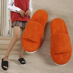 Detail view of fluffy orange towel slippers and model wearing black platform fuzzy slides.