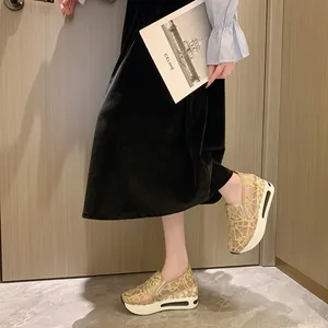 Detailed view of women's gold lace mesh platform wedge shoes with breathable slip-on design