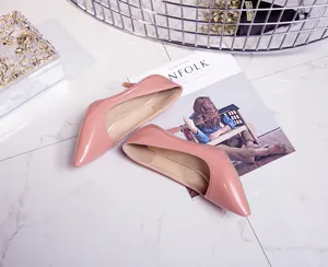 Detail of elegant pink patent leather pointed-toe stiletto pumps for women