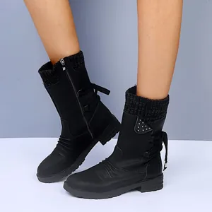Close-up detail of women's black mid-calf boots showing knit cuff and stylish block heel