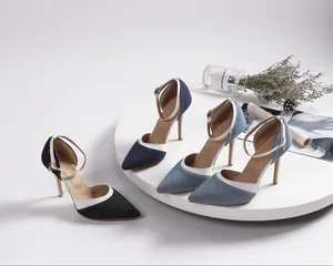 Close-up of denim pointed-toe stiletto heels with ankle straps in various colors.