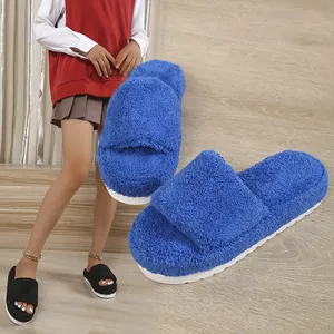Detailed view of the cozy blue fuzzy slippers with a thick white platform sole