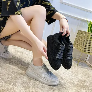 Close-up detail of women's luxury rhinestone platform sneakers in black and silver colors