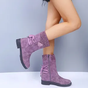 Purple mid-calf boots with knit cuffs and lace-up details shown on model legs