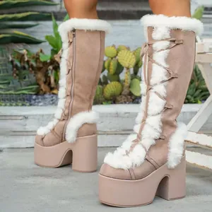 Close-up of Gothic Lolita platform boots with white faux fur trim and lace-up front.