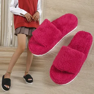 Detailed macro view of fuchsia fuzzy platform slippers with a thick towel-like texture