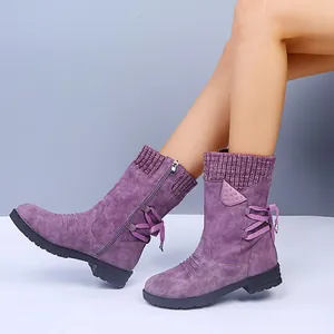 Detailed view of purple vintage mid-calf boots featuring back lacing and a knitted collar