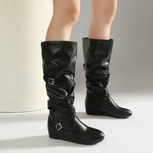 Elegant black slouchy mid-calf leather boots featuring decorative buckle straps and ruched design