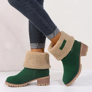Close-up of women's green suede winter boots with beige shearling fold-over collar.